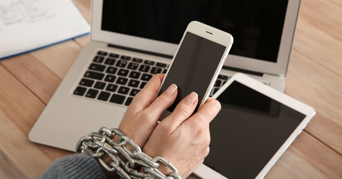 person on phone with chains on wrists