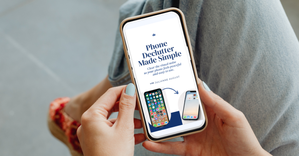 A person holds a smartphone displaying a workshop graphic about Digital Declutter with a before and after view showing a cluttered phone screen becoming simplified. The screen reads "Phone Declutter Made Simple. Clear the visual noise so your phone feels peaceful and easy to use. with Julianne August.